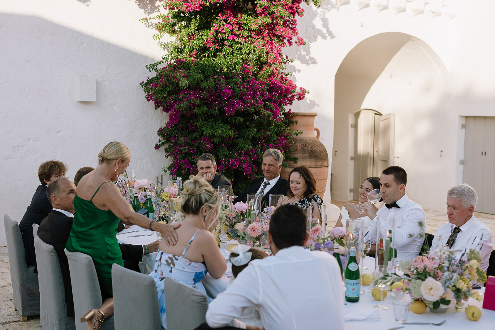 Guests gathered around a table in Petrarolo’s sunny courtyard