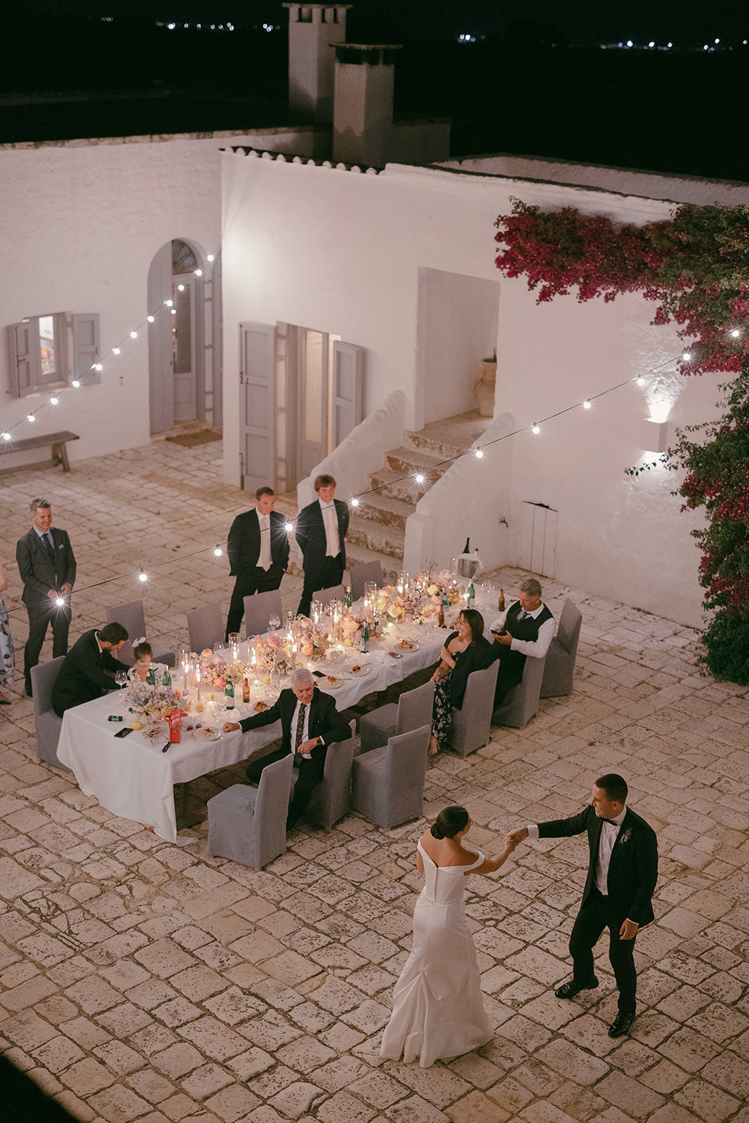 The wedding couple dancing in the candlelit courtyard at Masseria Petrarolo