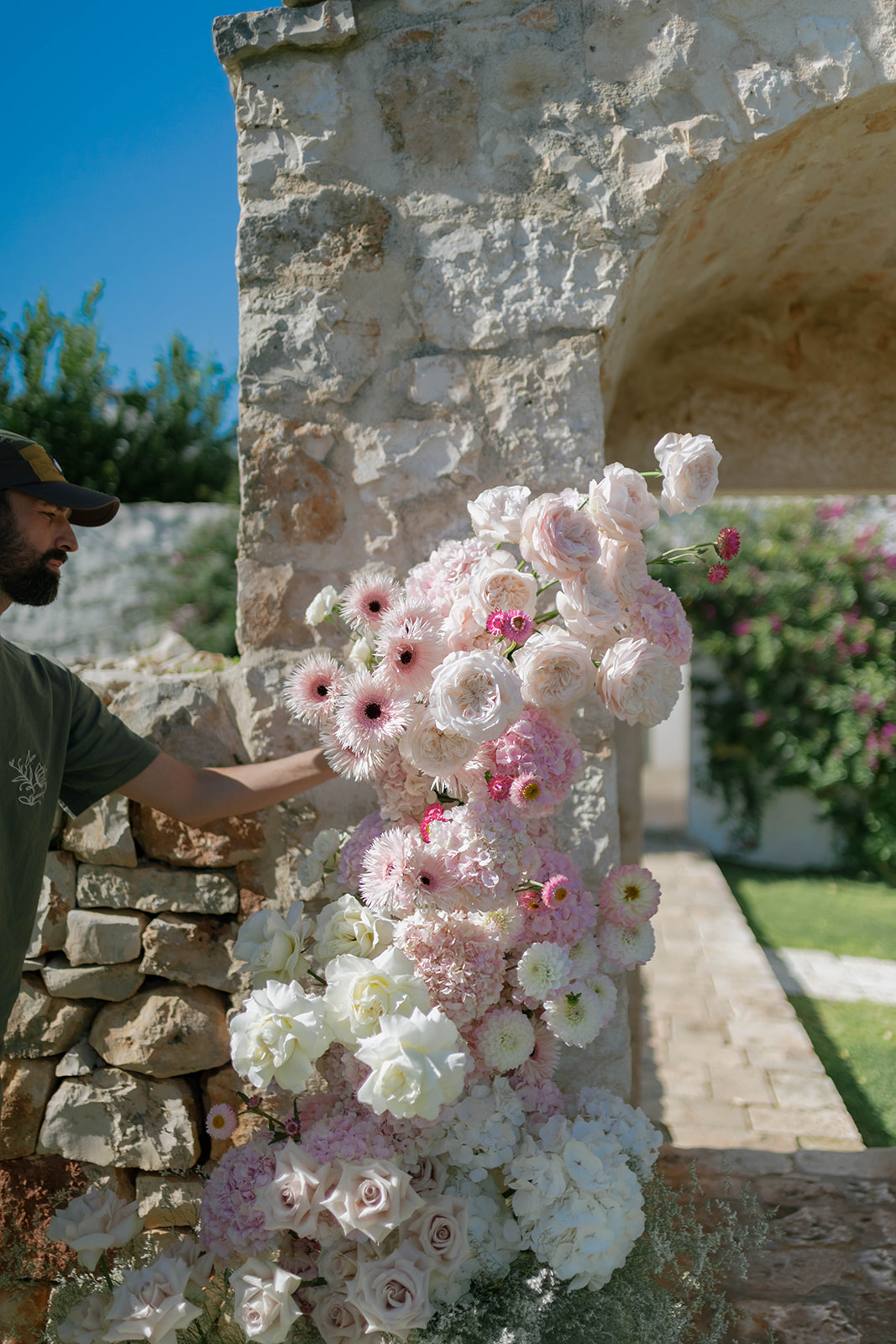 Wedding flowers against Petrarolo’s old stone walls
