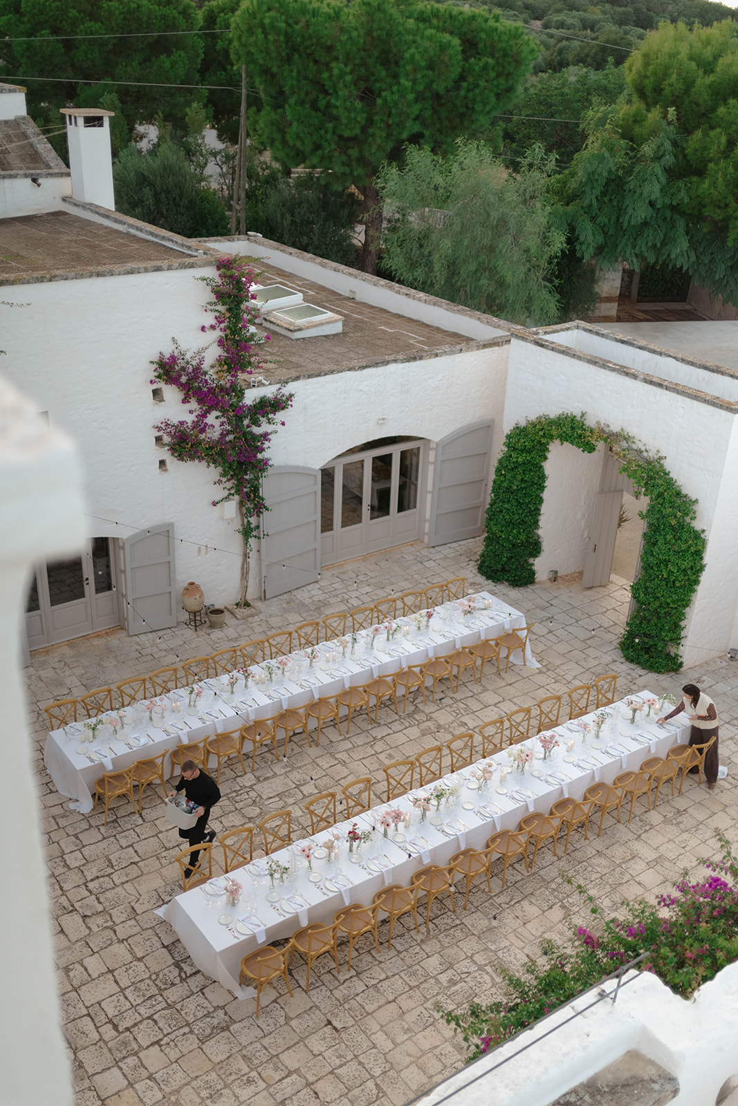 The courtyard prepared for a wedding dinner