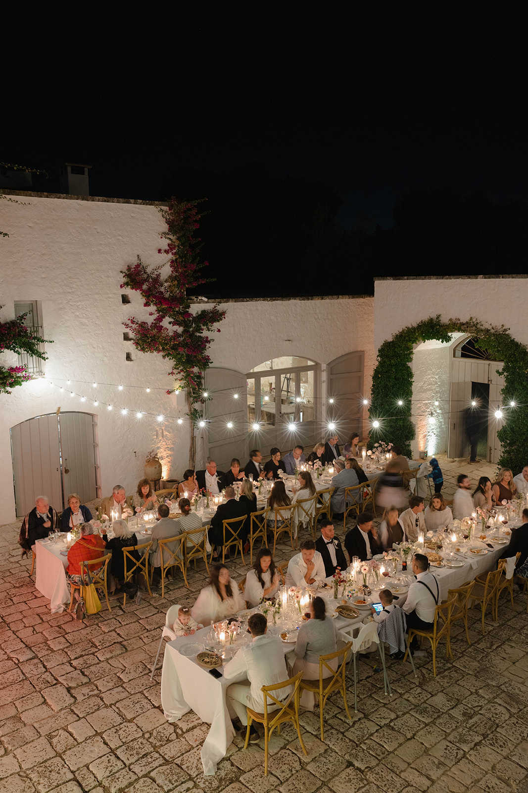 A wedding dinner beneath the evening lights