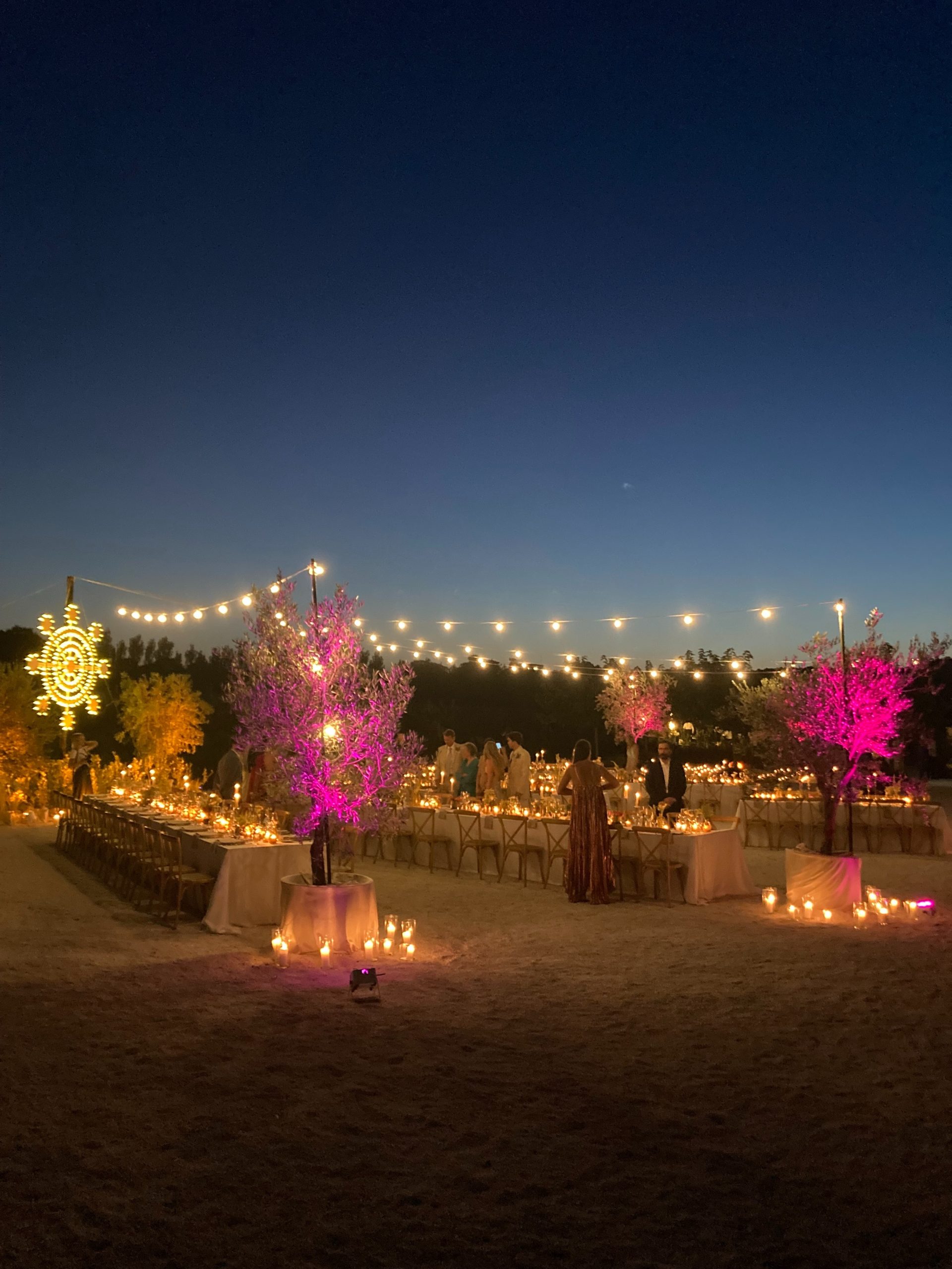 Open-air wedding dinner on Terrazza Due at Giardini Pistola, with candlelit tables and festoon lights
