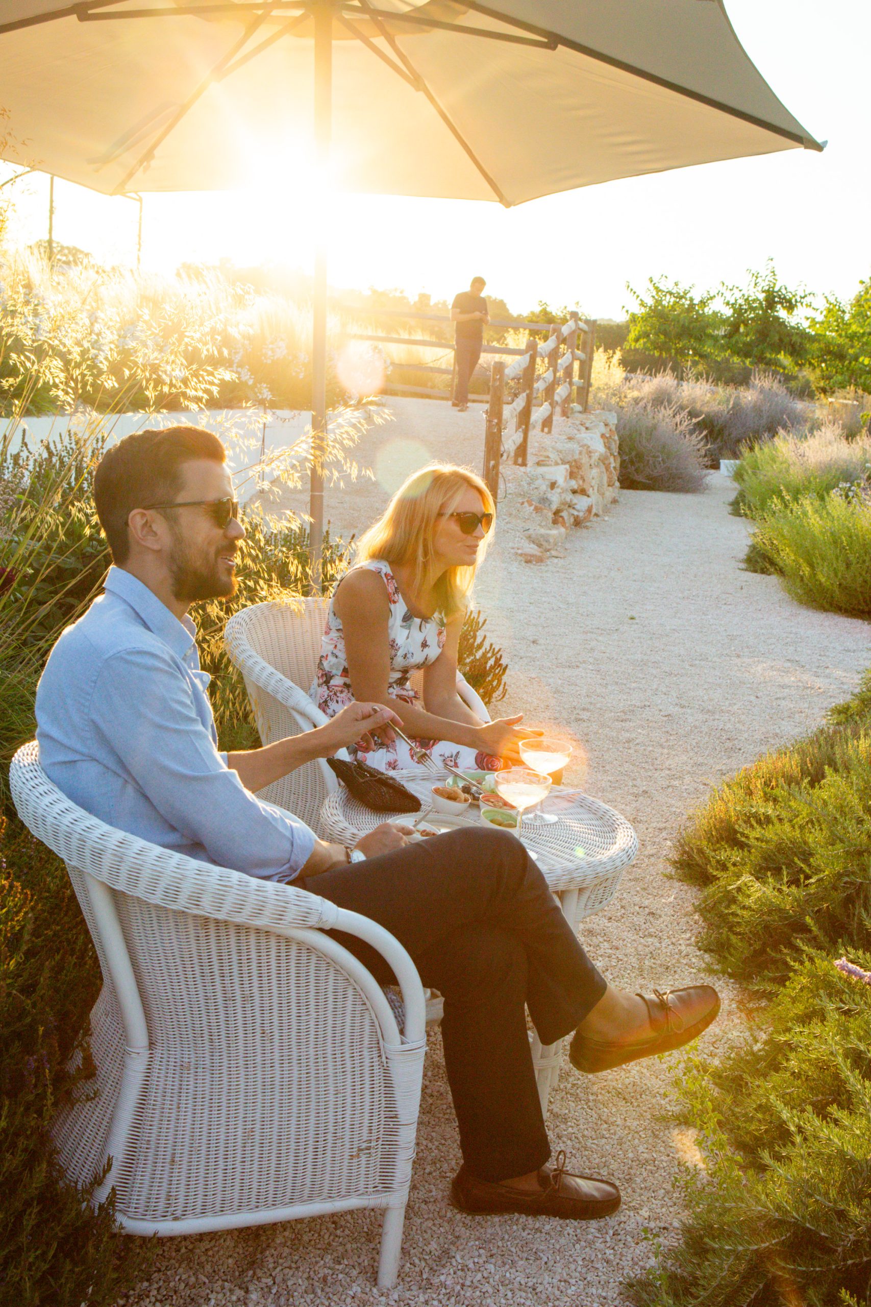 Guests chatting in golden evening sunlight